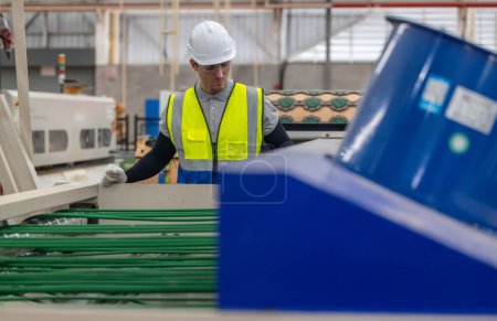Photo for Skilled technician ensures machinery stays in optimal condition. Regular inspections, tests, repairs, upholding standards. Identifying malfunctions, errors for smooth operations in cardboard factory. - Royalty Free Image