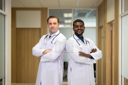 Photo for Group of diverse, experienced doctors from different of filed gathering as primary healthcare team. Creating positive relationships with colleagues. Smiling, sharing ideas the during break. - Royalty Free Image