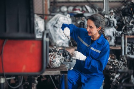 Photo for Car service technicians expertly inspect, assess engine parts in storage. Carefully selecting quality gears and instruments for precise repairs, modify, assembly. Assuring optimal vehicle performance - Royalty Free Image
