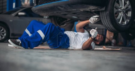 Photo for Car service technicians inspect, analyze, diagnose suspension system issues in garage with precise tools. Detect, troubleshoot, repair problems. Ensuring optimal vehicle performance and safety. - Royalty Free Image