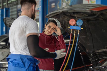 Photo for Car service technician inspect, evaluate, inform consumers about complex mechanical problems. Creating action plans, work schedules. Offering customized solutions and quotes depending on requirements - Royalty Free Image
