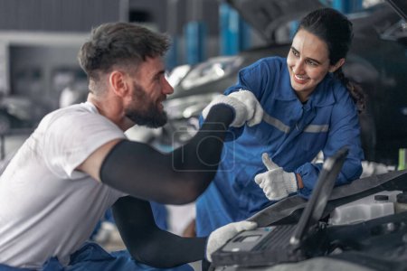 Photo for Skilled car service technicians utilize advanced computerized diagnostics and precise tools in garage workshop to analyze, troubleshoot, repair engine and system issues, ensuring optimal performance. - Royalty Free Image