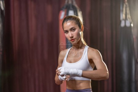 Photo for Portrait of a female boxing enthusiast in the ring, demonstrating consistent dedication and ability in a struggle for success, aspiring to become a professional athlete. - Royalty Free Image