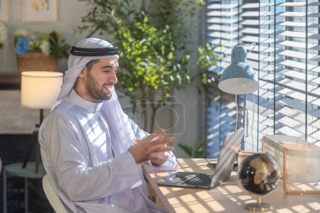 Sheikh, CEO en vestido árabe, supervisando negocios, reuniones a distancia, y la comunicación a través de videollamadas con el equipo con un gesto de sonrisa. Supervisar las operaciones como líder, mostrando responsabilidades.