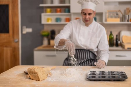 Photo for Professional master chef intently kneading on a flour surface at initial stages of bread making in a commercial kitchen. Showcasing skills, technique, precision, passion and artistry for food. - Royalty Free Image