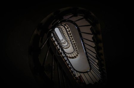 Photo for Elliptical wooden stairwell of an old building in the streets of central Paris, the capital of France, in August 2012 - Royalty Free Image