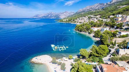 Photo for Beautiful Punta Rata beach in Brela, Croatia, aerial view. Adriatic Sea with amazing turquoise clean water and white sand on the beach. - Royalty Free Image