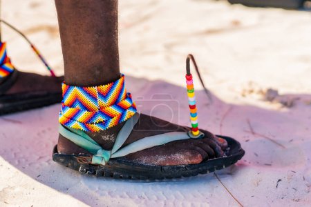 Téléchargez les photos : Travelling Kenya, Masai clothing and accessories details from Diani Beach Kendwa beach Zanzibar Kendwa Tanzania. Flip flops sandals of the Masai close up - en image libre de droit