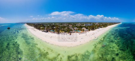 Photo for This aerial photo of Kiwengwa Beach in Zanzibar showcases the stunning natural beauty of the island, with its golden sand, turquoise waters, and lush foliage creating the perfect backdrop for a relaxing vacation. - Royalty Free Image