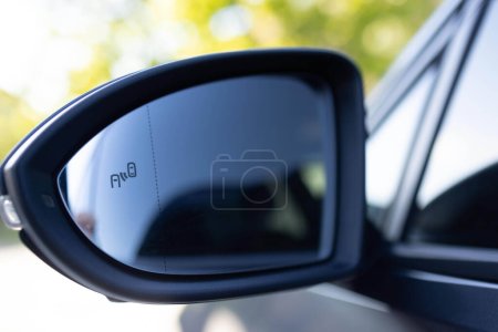 Photo for System blind spots of the car. Detail of side keeping assist system switch button. Blind zone monitoring sensor on the side mirror of a modern electric car. - Royalty Free Image