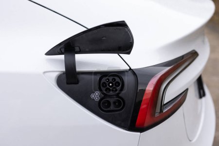 Fast charging socket type 2 combo electric car. Eco friendly alternative energy green environment concept. Type 2 CCS plug port on electric vehicle. DC - CCS type 2 EV charging connector at EV car.