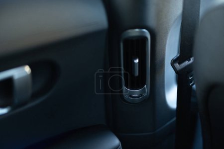 Interior details of a modern car Close-up view of car air vents. Air ventilation for rear passengers. Deflectors for rear passengers. Climate control rear passengers, air ducts on car panel.