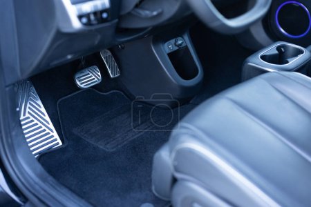 Electric car interior details. Vehicle Gas Brake Pedal, car pedals. Detailing of modern electric car, Brake and accelerator pedal of electric car interior. Brakes and accelerator pedals EV vehicle