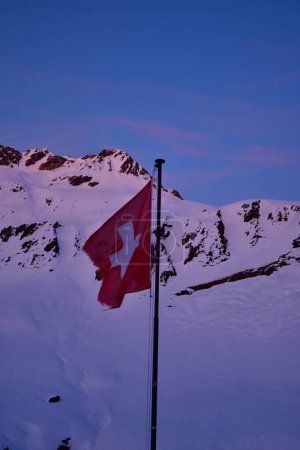 Swiss Flag in Dawn on Vermigel Hut Andermatt swizerland. High quality photo