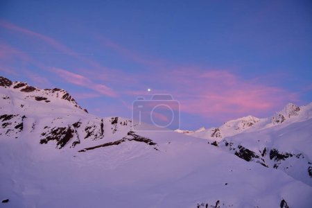 Dusk in swiss alps vermigel hut near Andermatt winter snow moon. High quality photo