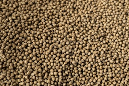 Fishery feed for fish feed. Fish feed pellets, close up of granulated fish food textur