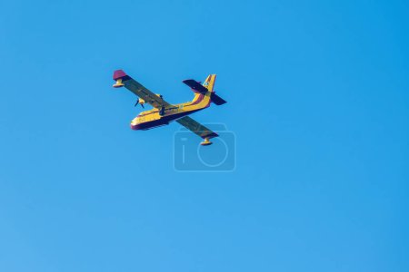 Photo for Old style airplane flying on blue sky - Royalty Free Image
