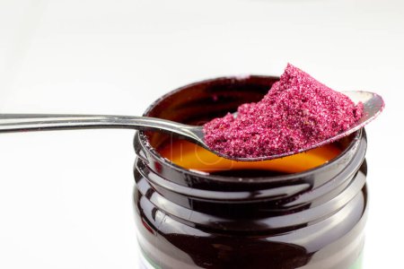 beetroot powder in spoon with plastic jar or instant borsch