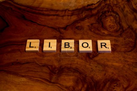 Photo for LIBOR (abbreviation for London Interbank Offered Rate) written with wooden letter blocks as a concept for IBOR discontinuation and transition to risk free rate SOFR and SONIA and Term SOFR - Royalty Free Image