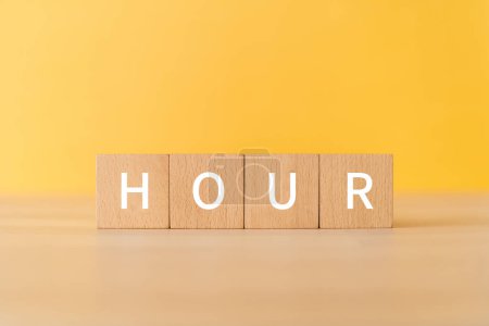 Photo for Wooden blocks with "HOUR" text of concept. - Royalty Free Image