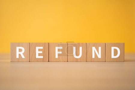 Wooden blocks with "REFUND" text of concept.