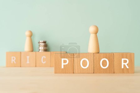Photo for Wooden blocks with "POOR" text of concept, human toys, and money. - Royalty Free Image