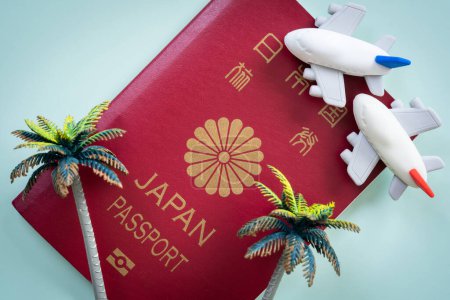 Foto de Japanese passport and airplane toys. Travel concept - Imagen libre de derechos