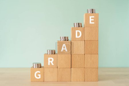 Photo for Wooden blocks with "GRADE" text of concept and coins. - Royalty Free Image