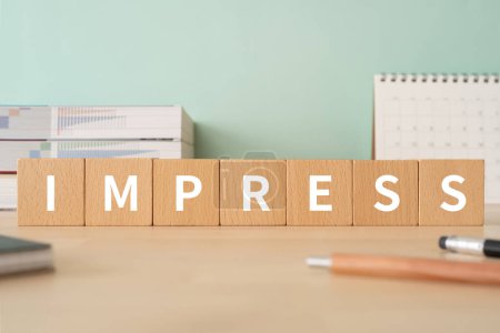 Photo for Wooden blocks with "IMPRESS" text on table, concept. - Royalty Free Image