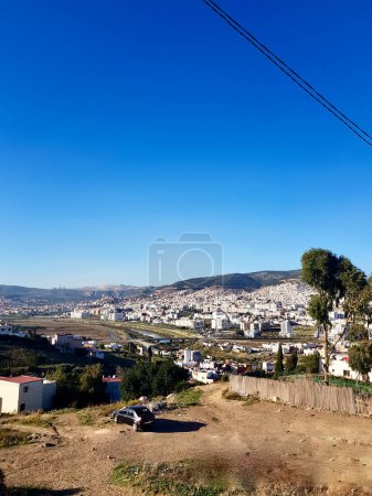Photo for Beyond the horizon a distant city looming, the urban landscape unfolds like a intricate tapestry. In the foreground, a city thrums with life, verdant expanse separates the two, reminder of the nature. - Royalty Free Image
