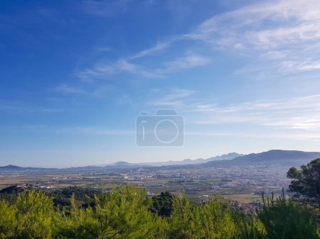 Panoramic view of the city of Tetouan, Morocco. The city is situated on a slope, and it is surrounded by green hills and mountains. Stunning example of the beauty and history of Moroccan architecture