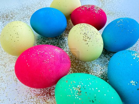 Colorful Easter eggs with glitter on a sparkling background, festive holiday decoration and celebration concept with copy space. Can be used for seasonal greeting cards, holiday party invitations