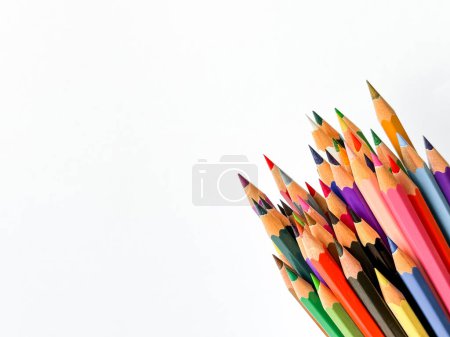 Assorted sharpened colorful pencils pointing up on white background with copy space for text. Concept of artistic or school supplies for design, teaching and educational purposes. High quality photo