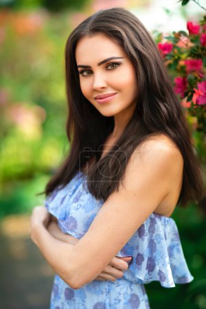 Photo for Portrait of a Beautiful girl in a crown  standing near flowers. Art work of romantic woman . - Royalty Free Image