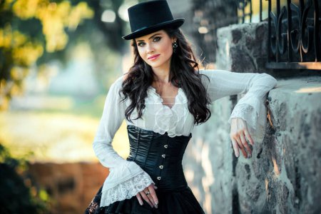 Photo for Portrait of magnificent Fashion gothic girl  .Fantasy art work.Amazing brunette model in black white dress and hat posing.Fairytale about young princess - Royalty Free Image