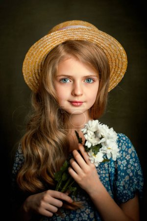 Close up Portrait of a Beautiful blonde girl with blue eyes in vintage dress  .Pretty child with shiny curly hair posing in studio on dark background.