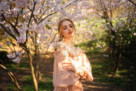 Photo for Beautiful  girl in pink vintage dress standing near colorful flowers. Art work of romantic woman .Pretty tenderness model posing  in blossom park. - Royalty Free Image