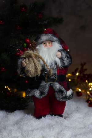 Photo for Forest wizard or Santa Claus against the background of a Christmas tree and lights close-up - Royalty Free Image