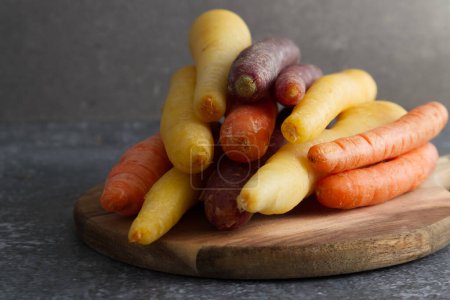 Photo for Rainbow carrots on a wooden stand close-up, yellow, purple, orange. High quality photo - Royalty Free Image