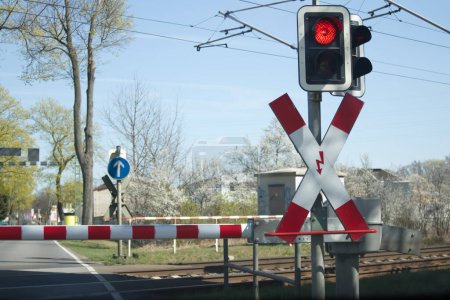 Photo for Red light of the railway crossing and lowered barrier blocking the passage. High quality photo - Royalty Free Image