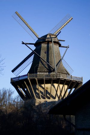 Photo for Fragment of an ancient wooden windmill against a blue safe sky copy space. High quality photo - Royalty Free Image