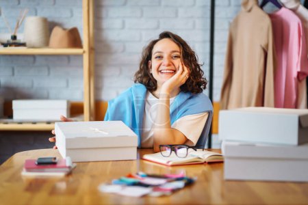 Photo for Small business owner, entrepreneur, seller  checking ecommerce clothing store orders  working in her office. Online sales. - Royalty Free Image