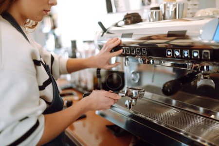 Foto de Chica barista preparando delicioso café caliente fresco en la máquina de café profesional. Comida para llevar. - Imagen libre de derechos
