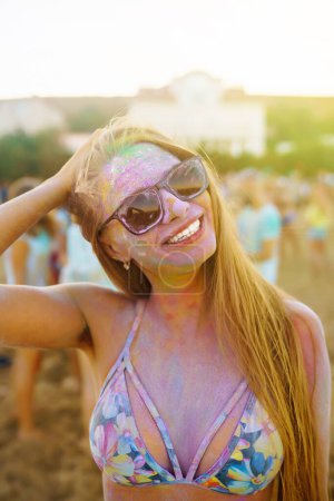 Photo for Young friends tuna and have fun at holi festival. Beach party on vacation. Friendship, rest. Traditional Indian holiday. - Royalty Free Image