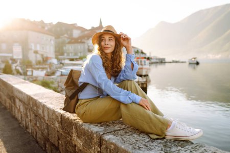 Young female tourist enjoys the view of the city. Europe travel. Lifestyle, vacation, tourism, nature, active life.