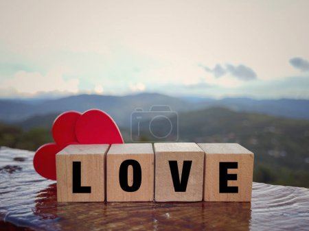 Photo for Motivational and inspirational word. LOVE word written on wooden blocks. With blurred styled background. - Royalty Free Image