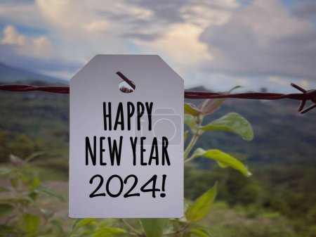Photo for New Year concept. Happy New Year 2024 written on a paper. With blurred styled background. - Royalty Free Image