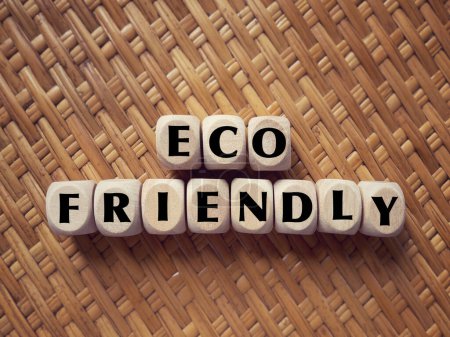 Photo for Nature conservation and awareness concept. ECO FRIENDLY written on wooden blocks. On blurred styled background. - Royalty Free Image