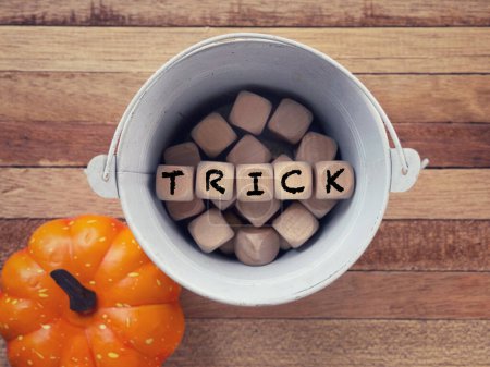 Photo for October celebration and Halloween concept. TRICK written on wooden blocks. With blurred styled background. - Royalty Free Image