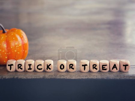 Photo for October celebration and Halloween concept. TRICK OR TREAT written on wooden blocks. With blurred styled background. - Royalty Free Image